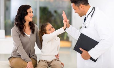 little girl and paediatrician doing high five 521786711 1000x667