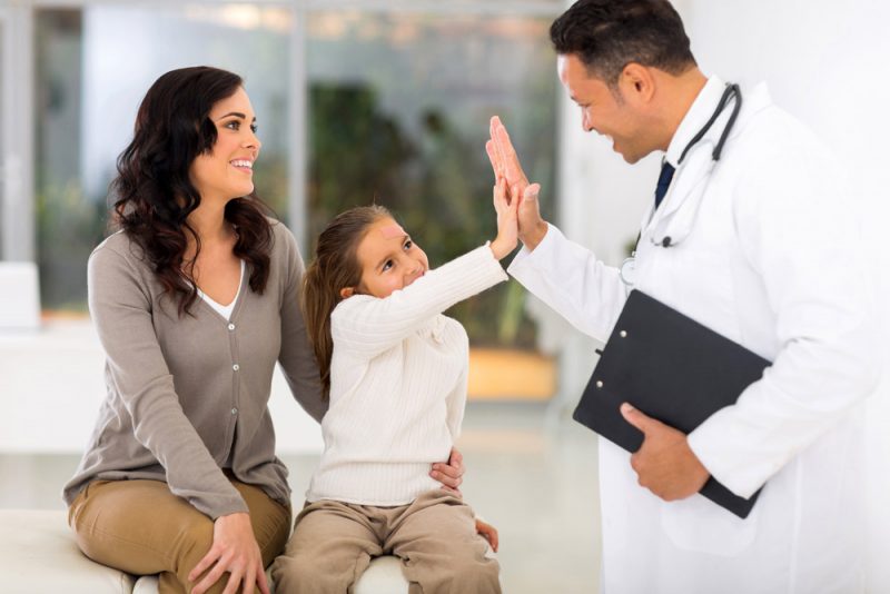 little girl and paediatrician doing high five 521786711 1000x667